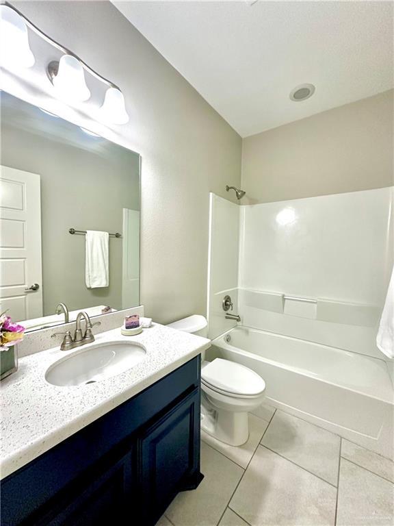 full bathroom with tile patterned floors, vanity, toilet, and tub / shower combination