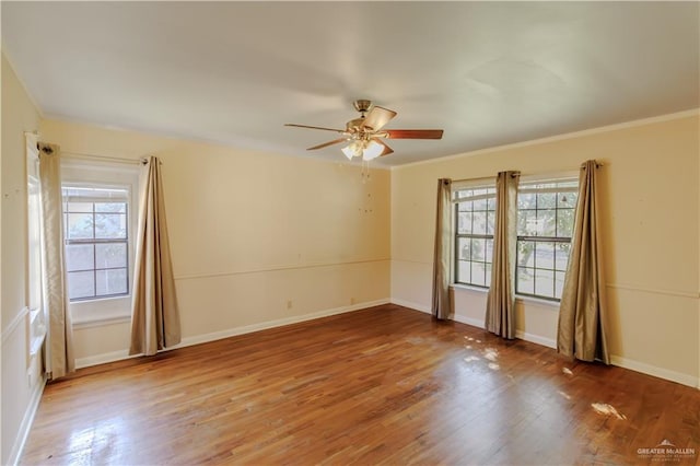1150 N Bowie St, San Benito, TX 78586 - spare room featuring plenty of natural light, ceiling fan, wood finished floors, and crown molding