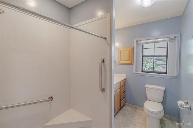 1150 N Bowie St, San Benito, TX 78586 - bathroom with vanity, toilet, baseboards, and a shower