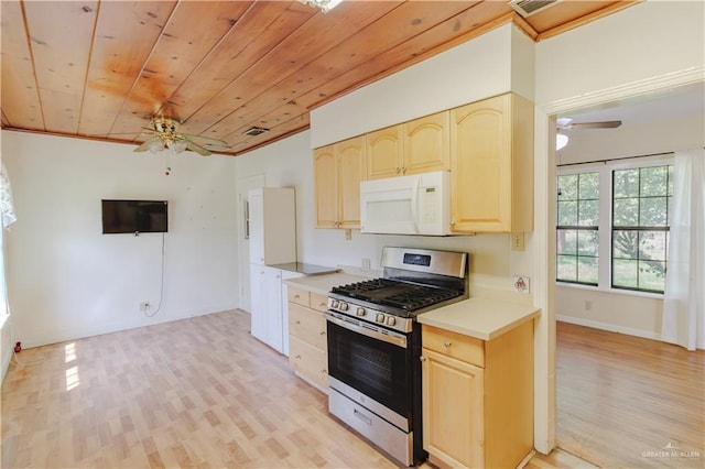 1150 N Bowie St, San Benito, TX 78586 - kitchen featuring stainless steel range with gas cooktop, white microwave, ceiling fan, light brown cabinets, and wooden ceiling