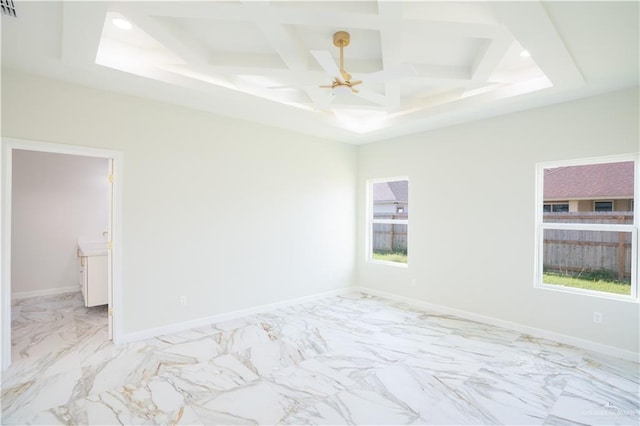 spare room with beamed ceiling, a wealth of natural light, coffered ceiling, and ceiling fan