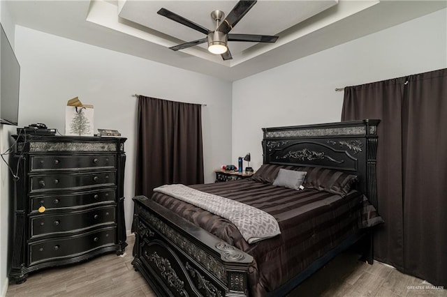 bedroom featuring ceiling fan and a tray ceiling