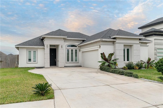 prairie-style house featuring a front yard and a garage