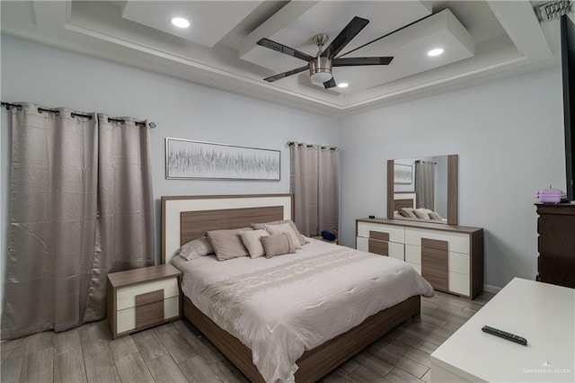 bedroom with a tray ceiling and ceiling fan