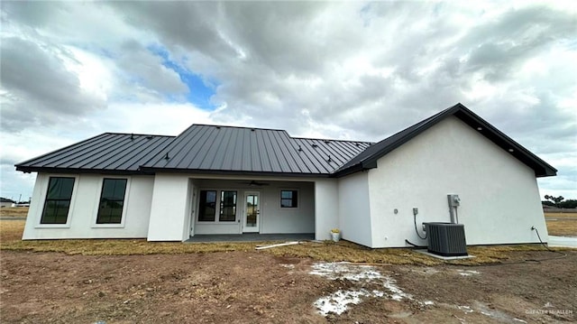 rear view of house featuring central AC, ceiling fan, and a patio area