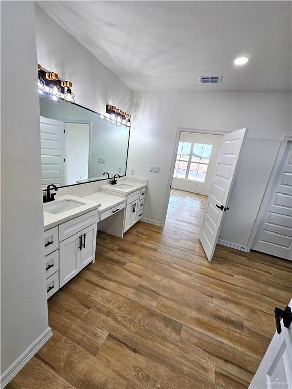 bathroom with vanity and hardwood / wood-style floors