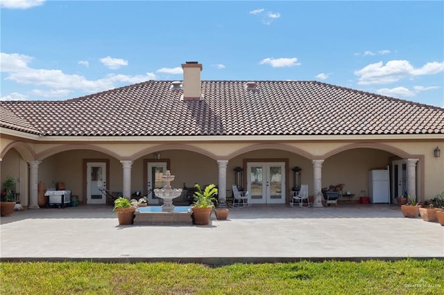 back of property featuring a patio and french doors