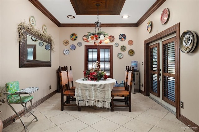 tiled dining area with french doors, a tray ceiling, and ornamental molding