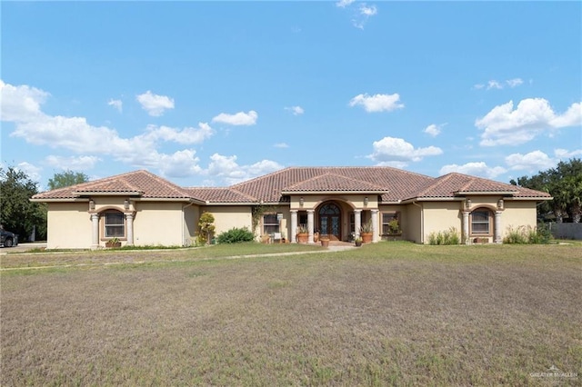 mediterranean / spanish-style house with a front yard