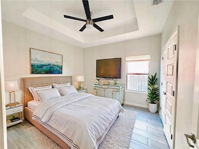 8706 Pink Flamingo St, Harlingen, TX 78552 - bedroom featuring a raised ceiling, ceiling fan, and light wood finished floors