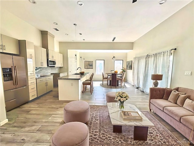 8706 Pink Flamingo St, Harlingen, TX 78552 - living room with light wood-style flooring and recessed lighting