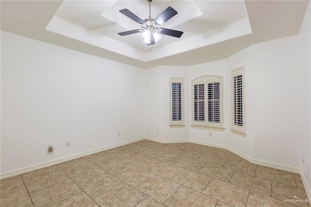 unfurnished room with a tray ceiling and ceiling fan