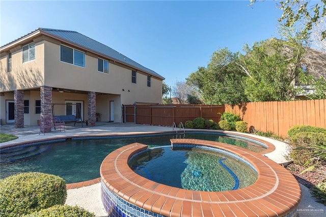 view of pool featuring an in ground hot tub and a patio area