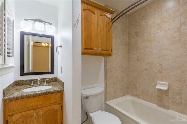 full bathroom featuring vanity, toilet, and tiled shower / bath