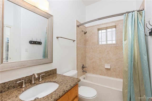 full bathroom featuring vanity, shower / bath combo, and toilet