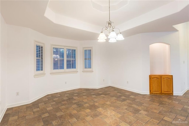 unfurnished room with a notable chandelier