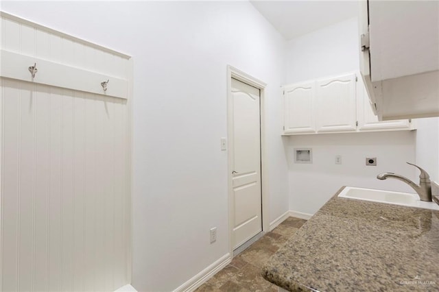 clothes washing area featuring hookup for an electric dryer, cabinets, sink, and washer hookup