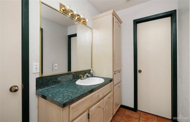 bathroom featuring tile patterned floors, vanity, and a textured ceiling