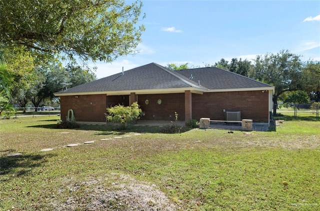 view of home's exterior featuring a lawn and central AC unit