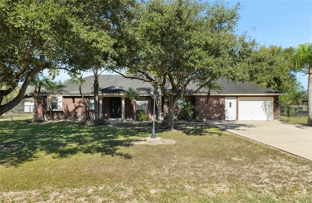 single story home featuring a garage and a front lawn