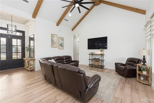 living room with high vaulted ceiling, light wood-type flooring, and beam ceiling