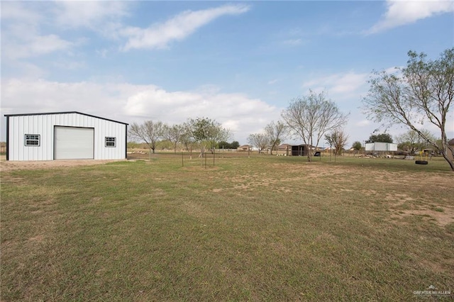 view of yard with an outbuilding and a detached garage