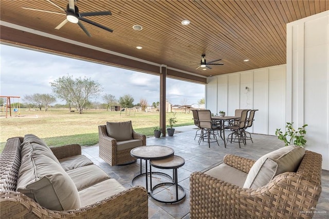 view of patio / terrace with outdoor dining area, ceiling fan, and an outdoor hangout area