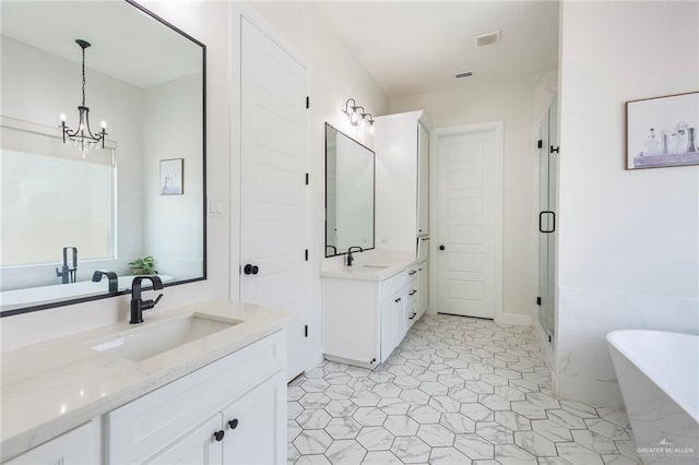 full bath featuring a freestanding tub, two vanities, a sink, visible vents, and a stall shower