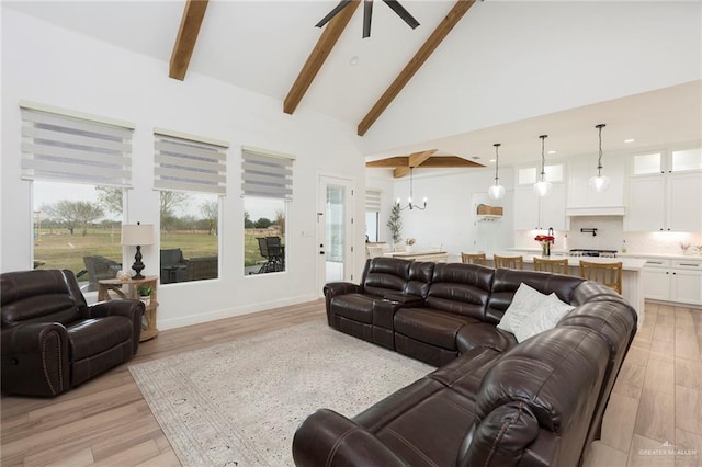 living room with light wood-type flooring, high vaulted ceiling, and beamed ceiling