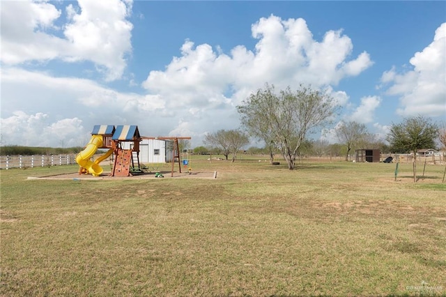 view of yard with playground community and fence