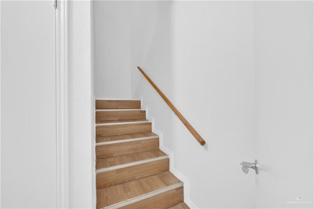 stairs featuring wood finished floors