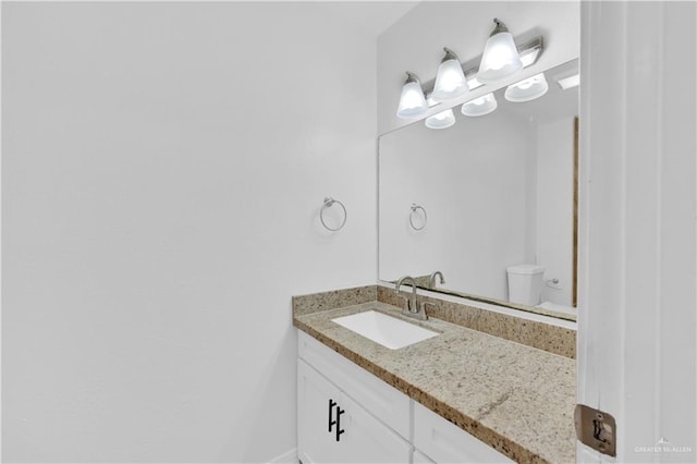 half bathroom featuring vanity