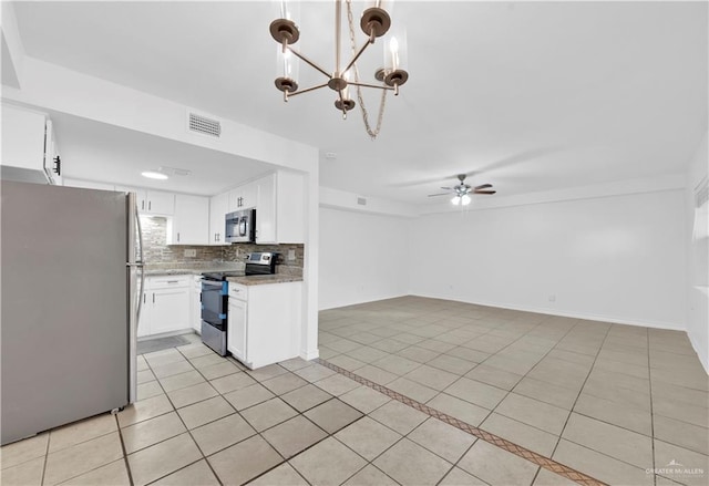 kitchen featuring open floor plan, white cabinets, ceiling fan with notable chandelier, light tile patterned floors, and stainless steel appliances
