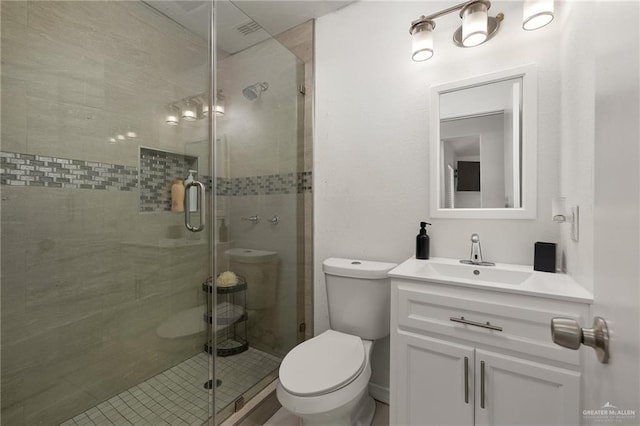 3408 Whiskey Dr, Pharr, TX 78577 - bathroom featuring toilet, a stall shower, and vanity