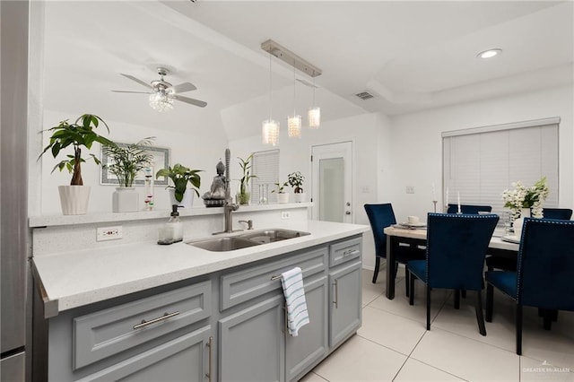3408 Whiskey Dr, Pharr, TX 78577 - kitchen with gray cabinetry, light tile patterned floors, light countertops, a ceiling fan, and a sink
