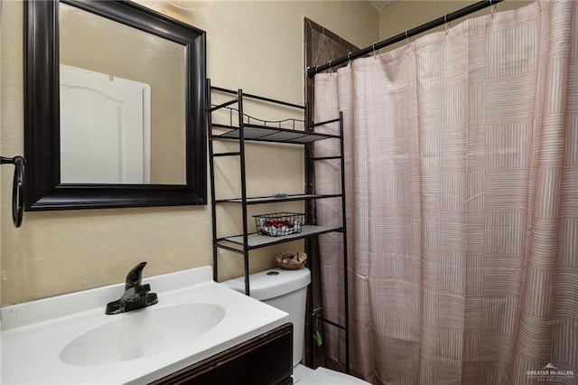 bathroom featuring vanity, toilet, and curtained shower