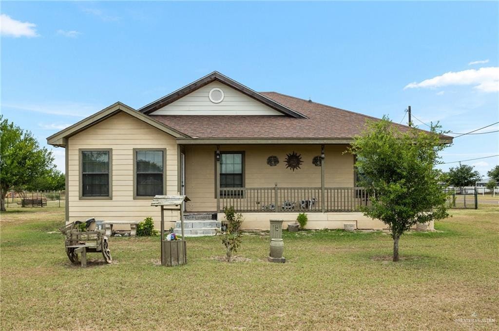 22504 N Val Verde Rd, Edcouch, TX 78538 - view of front of home with roof with shingles, covered porch, and a front lawn