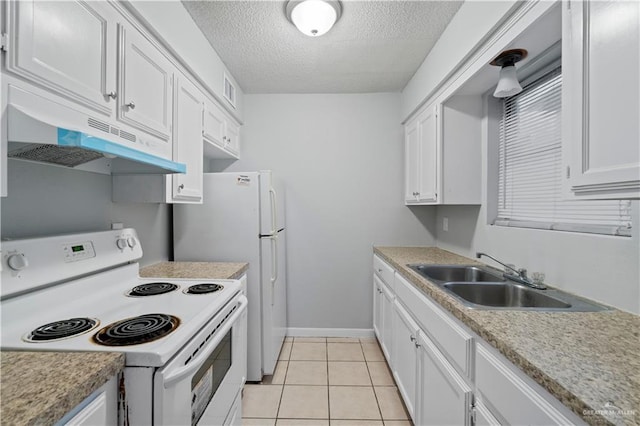 kitchen with white electric range, sink, light tile patterned floors, a textured ceiling, and white cabinetry