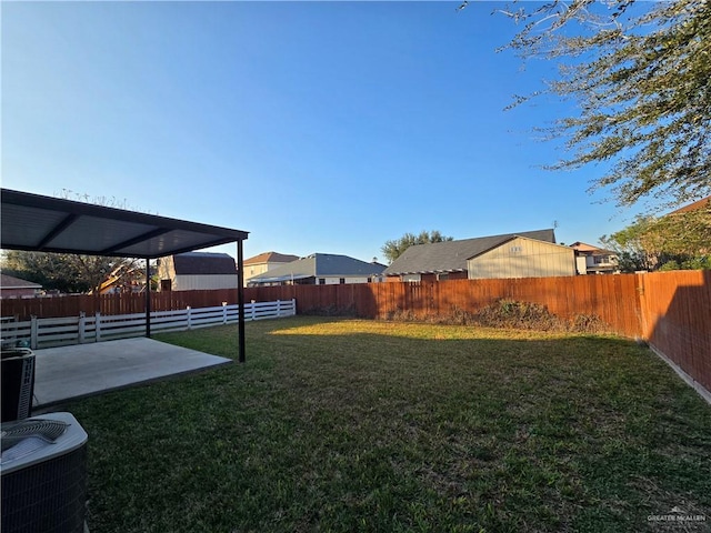 view of yard with a patio and central AC unit