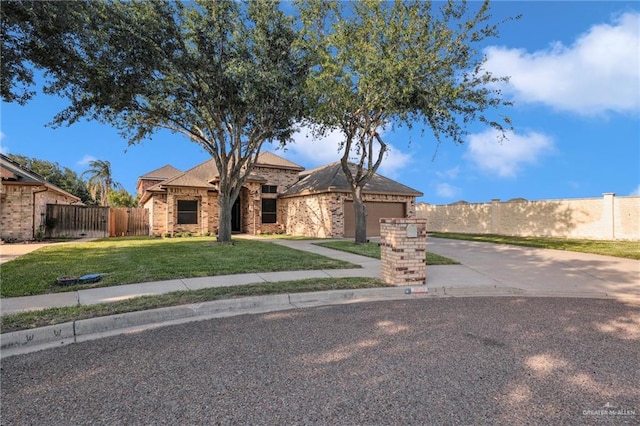 2600 Northgate Ln, Mcallen, TX 78504 - single story home featuring a garage, brick siding, fence, a front lawn, and concrete driveway