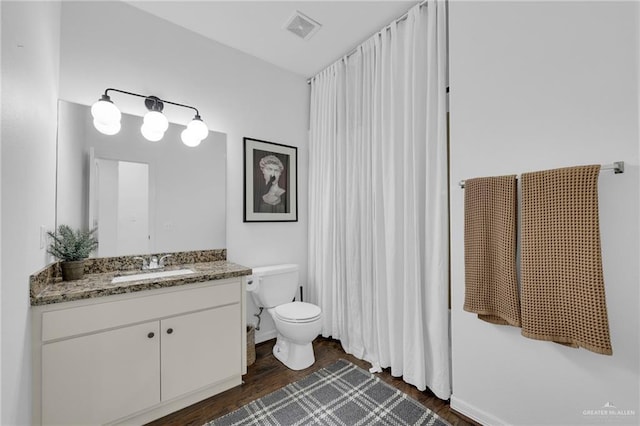 2600 Northgate Ln, Mcallen, TX 78504 - full bathroom featuring vanity, toilet, wood finished floors, and visible vents