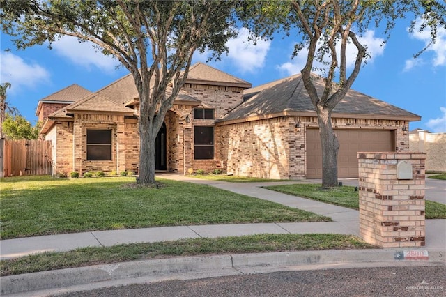 2600 Northgate Ln, Mcallen, TX 78504 - view of front of property featuring brick siding, a garage, fence, and a front yard