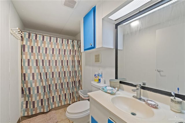 bathroom featuring tile patterned flooring, vanity, a shower with shower curtain, and toilet