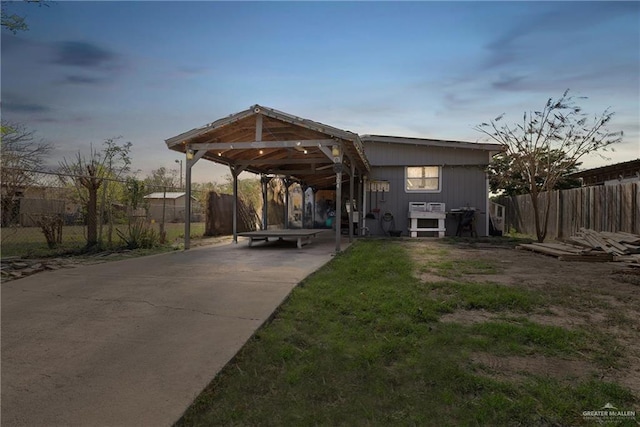 back house at dusk with a carport