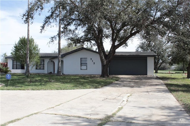 single story home featuring a garage and a front yard