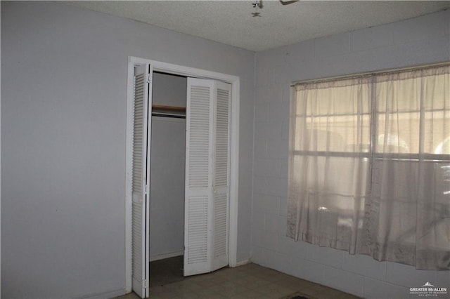 unfurnished bedroom with a textured ceiling