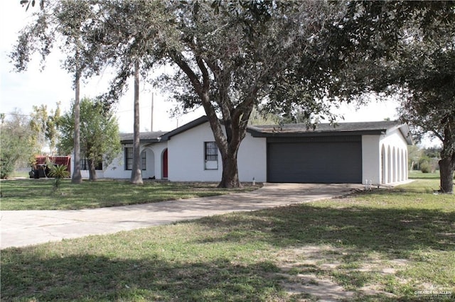 single story home featuring a garage and a front yard