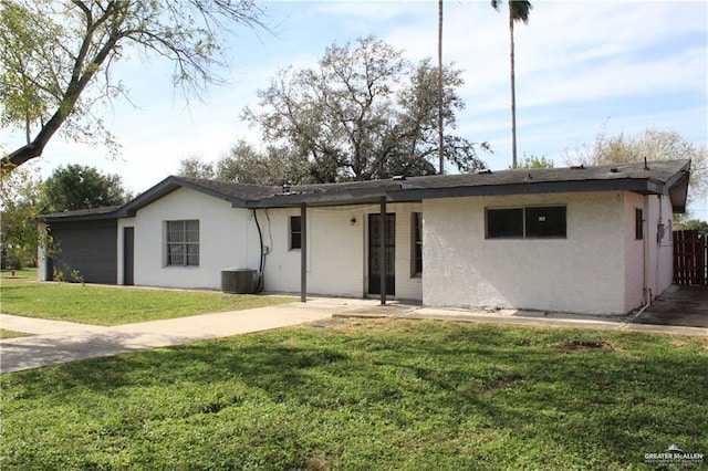 ranch-style home featuring central AC and a front lawn