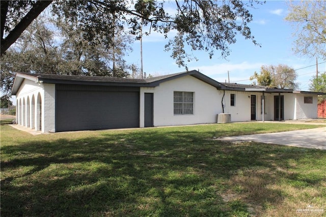 ranch-style home featuring a garage and a front yard