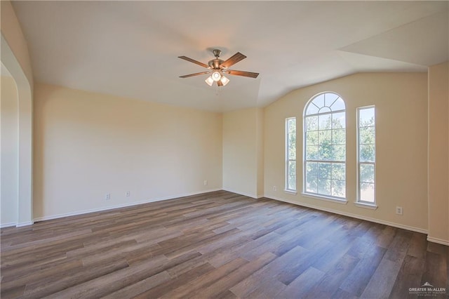 empty room with ceiling fan, lofted ceiling, and hardwood / wood-style flooring